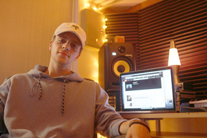 Junior Andy Polk sits in his closet-turned-studio, where he creates mixes for Soundcloud.