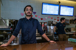 Graduate student, Nawazish Shaik, in Pages Cafe, where he works. Shaik is one of the students forming a union, seeking to improve wages, worker-manager relations and 